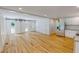 Open living area featuring a modern kitchen, stainless appliances, and hardwood floors at 9614 Quail Roost Rd, Bahama, NC 27503
