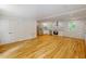 Open living area with a modern kitchen, stainless appliances, and hardwood floors at 9614 Quail Roost Rd, Bahama, NC 27503