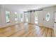 Bright living area with hardwood floors, barn doors, and large windows offering scenic outdoor views at 9614 Quail Roost Rd, Bahama, NC 27503