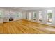Bright living area featuring hardwood floors, white walls, and large windows offering scenic views at 9614 Quail Roost Rd, Bahama, NC 27503