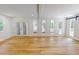 Bright living room with hardwood floors, natural light, and sliding barn door to the exterior at 9614 Quail Roost Rd, Bahama, NC 27503