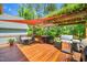 Entertaining deck with pergola, outdoor cooking, and comfortable seating area at 100 Mill Creek Dr, Fuquay Varina, NC 27526