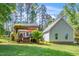 Beautiful backyard featuring a covered deck, green lawn, and mature trees at 100 Mill Creek Dr, Fuquay Varina, NC 27526