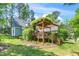 Spacious backyard with wooden deck, pergola, and lush landscaping at 100 Mill Creek Dr, Fuquay Varina, NC 27526