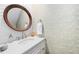 Charming powder room features white cabinets, round mirror, and floral wallpaper at 100 Mill Creek Dr, Fuquay Varina, NC 27526