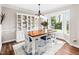 Formal dining room featuring hardwood floors, large window, and a dining table with seating at 100 Mill Creek Dr, Fuquay Varina, NC 27526