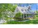 Beautiful home with a lush front yard, American flag, and inviting front porch at 100 Mill Creek Dr, Fuquay Varina, NC 27526