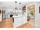 Modern kitchen featuring white cabinets, stainless steel appliances, granite countertops, and wood floors at 100 Mill Creek Dr, Fuquay Varina, NC 27526