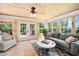 Bright sun room featuring wood paneled walls, a ceiling fan, neutral furniture, and a tile floor at 100 Mill Creek Dr, Fuquay Varina, NC 27526