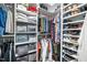 Organized walk-in closet with shelving, hanging rods, and ample storage space for clothes and shoes at 100 Mill Creek Dr, Fuquay Varina, NC 27526