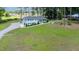 Aerial view of a home surrounded by an expansive lawn and mature trees at 103 Rex Pl, Louisburg, NC 27549