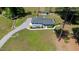 Aerial view of a well-maintained property with a lush lawn, mature trees, and circular driveway at 103 Rex Pl, Louisburg, NC 27549