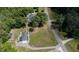 Aerial perspective showing houses with large lawns and a road, surrounded by mature trees and greenery at 103 Rex Pl, Louisburg, NC 27549