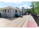 Large wooden back deck with a black metal safety railing at 103 Rex Pl, Louisburg, NC 27549