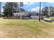 A large, inviting wooden back deck offers plenty of space for outdoor seating and entertaining at 103 Rex Pl, Louisburg, NC 27549