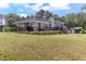 Back yard view of a home showcasing a wooden deck with black metal railing, creating an inviting outdoor space at 103 Rex Pl, Louisburg, NC 27549