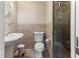 Neutral toned bathroom with glass enclosed shower and pedestal sink at 103 Rex Pl, Louisburg, NC 27549