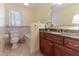 Well-lit bathroom with granite countertops, tiled floors, and a separate toilet area at 103 Rex Pl, Louisburg, NC 27549