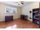 Bright bedroom with hardwood floors, a window, and furnished with a desk and bookcase at 103 Rex Pl, Louisburg, NC 27549