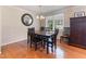 This dining room features hardwood floors and a stylish round mirror, creating an inviting space for meals at 103 Rex Pl, Louisburg, NC 27549