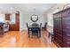 Charming dining room features hardwood floors and a stylish round mirror, enhancing the space's character at 103 Rex Pl, Louisburg, NC 27549