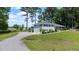 Inviting single Gathering home, featuring a lush green lawn and mature trees at 103 Rex Pl, Louisburg, NC 27549