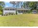 Charming light grey two-story home with a well manicured yard and mature trees at 103 Rex Pl, Louisburg, NC 27549