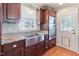 Kitchen featuring stainless steel appliances, granite countertops, and a stainless steel farmhouse sink at 103 Rex Pl, Louisburg, NC 27549