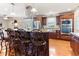 Open kitchen featuring stainless steel appliances, granite countertops, bar seating and hardwood floors at 103 Rex Pl, Louisburg, NC 27549