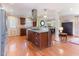 Kitchen featuring a center island with a cooktop, granite countertops, and wood floors at 103 Rex Pl, Louisburg, NC 27549