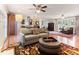 Open-concept living area with hardwood floors, comfortable seating, and seamless flow to the kitchen at 103 Rex Pl, Louisburg, NC 27549