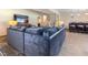 Open living room with cozy couch, tile floors, and staircase at 103 Rex Pl, Louisburg, NC 27549