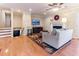 Inviting living room with hardwood floors, a cozy fireplace, and stairs leading to a lower level at 103 Rex Pl, Louisburg, NC 27549