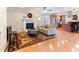 Cozy living room featuring a fireplace, hardwood floors, and open access to the kitchen at 103 Rex Pl, Louisburg, NC 27549
