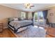 Serene main bedroom with hardwood floors, a ceiling fan, and access to a private outdoor space at 103 Rex Pl, Louisburg, NC 27549