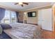 Spacious main bedroom with ceiling fan, and double doors to outside deck area at 103 Rex Pl, Louisburg, NC 27549