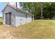 Outbuilding with a gray metal exterior and double door entry at 103 Rex Pl, Louisburg, NC 27549
