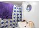 Bathroom with shower/tub combination, floral shower curtain, a white vanity and mirror at 105 E Cole St, Dunn, NC 28334