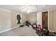 Bedroom featuring wall paneling, an open closet and carpeted floors at 105 E Cole St, Dunn, NC 28334