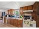 Functional kitchen space with light countertops, wooden cabinets, and an electric stovetop at 105 E Cole St, Dunn, NC 28334