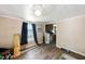 Living room featuring wood-look laminate flooring, natural lighting, and ceiling fan at 105 E Cole St, Dunn, NC 28334