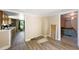 A view from a room with newer flooring of a nearby kitchen and possible bedroom spaces at 105 E Cole St, Dunn, NC 28334