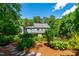 Charming backyard view of the house, framed by lush greenery and mature trees at 105 Juniper Ct, Carrboro, NC 27510