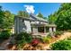 Lovely backyard with vibrant landscaping, a small patio area, and expansive windows at 105 Juniper Ct, Carrboro, NC 27510