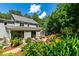Beautiful backyard showcasing colorful landscaping, a patio, and an expansive window feature at 105 Juniper Ct, Carrboro, NC 27510