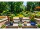 Beautifully landscaped backyard and stairs leading to the yard with lush greenery and colorful flowers at 105 Juniper Ct, Carrboro, NC 27510