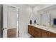 Bathroom featuring double sinks, granite countertops and a large mirror at 105 Juniper Ct, Carrboro, NC 27510