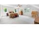 Spacious bedroom with three windows, a bed, an antique desk, and a dresser at 105 Juniper Ct, Carrboro, NC 27510