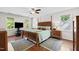 Bright, spacious bedroom featuring hardwood floors, neutral walls, and a wooden bed frame at 105 Juniper Ct, Carrboro, NC 27510