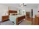 Inviting primary bedroom with elegant furnishings, a ceiling fan, and hardwood floors at 105 Juniper Ct, Carrboro, NC 27510